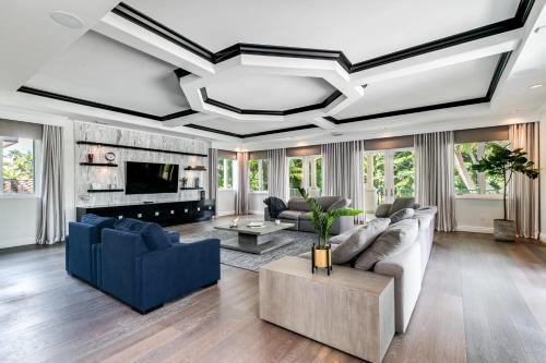a living room with a couch and a fireplace at Incredible 9 Bedroom 11 Bath Idlewyld Mansion in Fort Lauderdale