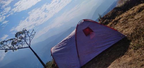 a purple tent sitting on the side of a mountain at HOTEL CAMPESTRE ABRAZO DEL ANGEL in Aratoca