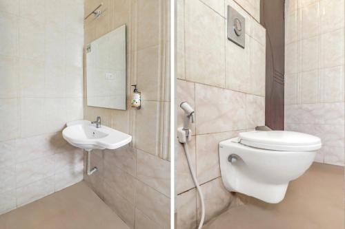 a bathroom with a toilet and a sink at Collection O 29 Church's Inn Near Cubbon Park in Bengaluru