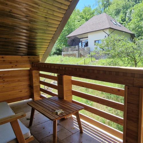 a porch with a bench and a house in the background at Provence Suceava in Suceava