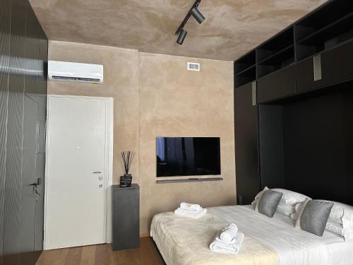 ミラノにあるSuite milano breraのベッドルーム(ベッド1台、薄型テレビ付)