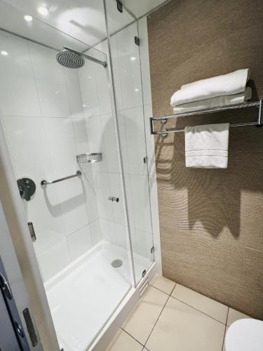 a shower with a glass door in a bathroom at Radisson Hotel Curico in Curicó
