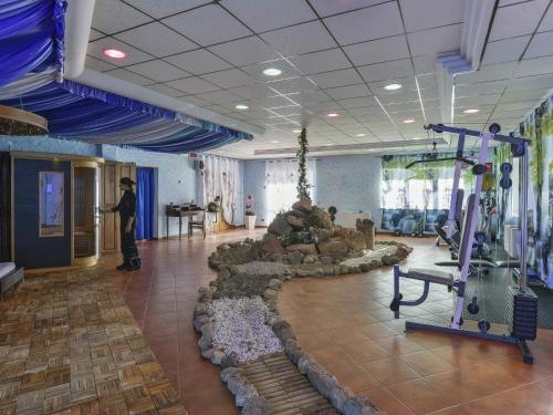 a person standing in a room with a gym at Albergo Le Macinaie - Monte Amiata in Castel del Piano