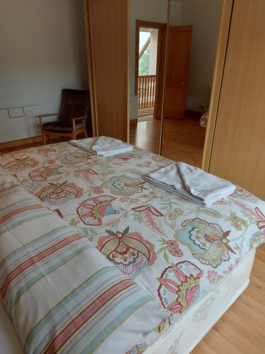 a bed with a colorful blanket on top of it at Tower House in Crawfordsburn