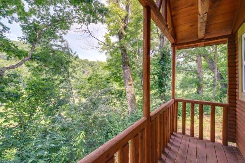 a porch of a cabin with a view of the woods at Cozy Cabin with Direct ATV Trail Riding and Mtn Views! in Caryville