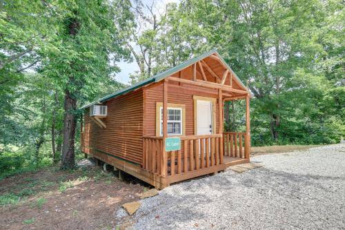 a wooden cabin in the middle of the woods at Cozy Cabin with Direct ATV Trail Riding and Mtn Views! in Caryville