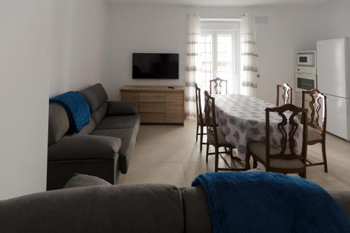 a living room with a couch and a table at apartamentos El-Hizan in Laujar de Andarax