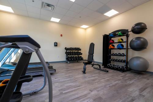 a gym with dumbbells and weights in a room at SPOT X Hotel Orlando Intl Dr by The Red Collection in Orlando