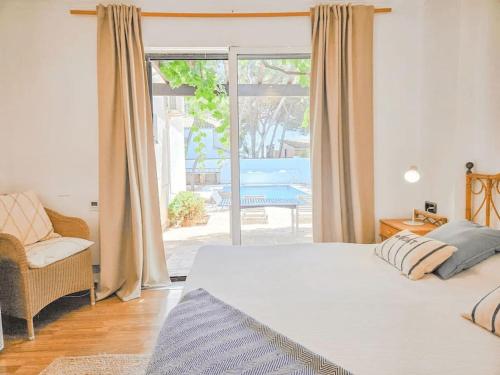 a bedroom with a bed and a sliding glass door at Villa Fuente Verde in Marbella