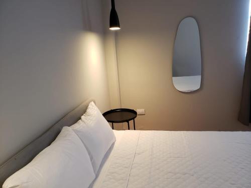 a bedroom with a bed with a pillow and a table at Singular Centro Histórico in Mexico City