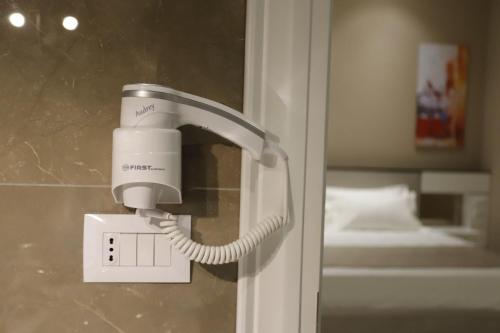 a soap dispenser on a wall in a bathroom at Admiral Hotel in Elbasan