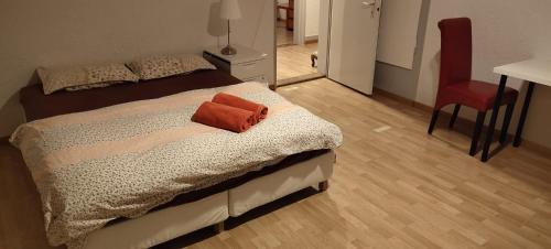 a bedroom with a bed with a red towel on it at City Home St Gallen in St. Gallen