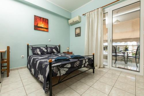 a bedroom with a bed and a balcony at Central Cozy Apartment 2 in Sparta