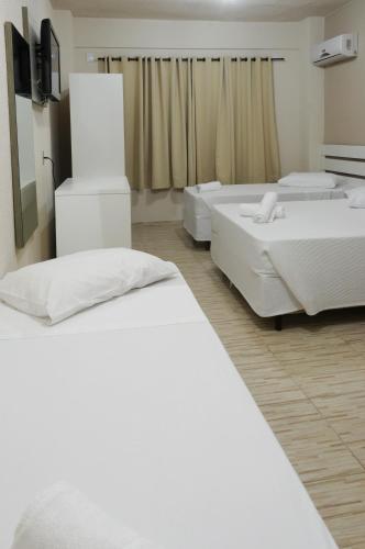 Ένα ή περισσότερα κρεβάτια σε δωμάτιο στο Hotel Conexão