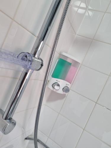 a glass shower door with a shower head in a bathroom at Your Home away from Home!-Comfy-Cosy in Headingley