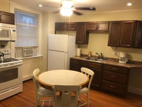a kitchen with a table and a white refrigerator at Walk to Downtown Salem in Salem