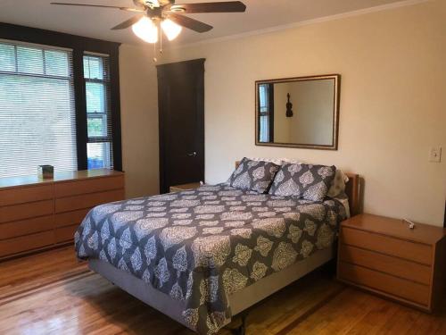 a bedroom with a bed and a ceiling fan at Walk to Downtown Salem in Salem
