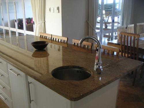 a kitchen counter with a sink in a kitchen at Waterside Living MM1394 in Jeffreys Bay