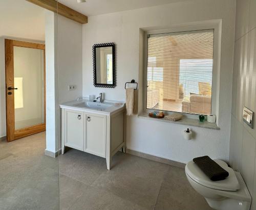 a bathroom with a sink and a toilet and a window at Ece Hotel Sovalye Island in Fethiye