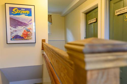 a hallway with a movie poster on the wall at Brass Lantern Inn in Stowe