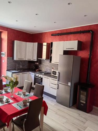 a kitchen with a table and a refrigerator at Il giglio bianco in Ischia di Castro