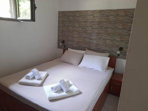 a bedroom with a bed with two towels on it at Summer Apartment in Kotor