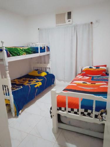 a bedroom with two bunk beds and a fan at casa pileta patio indio froilan estadio unico madre de ciudades in Santiago del Estero