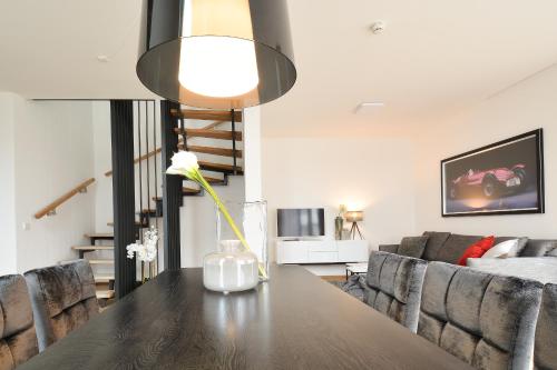 a living room with a table and a couch at Lunas Appartements Essen in Essen