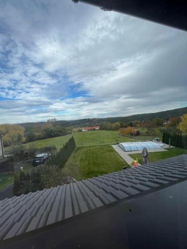 a view of a yard from a roof of a house at Vila v Brdech s bazénem, infra saunou a vybavením in Malá Víska