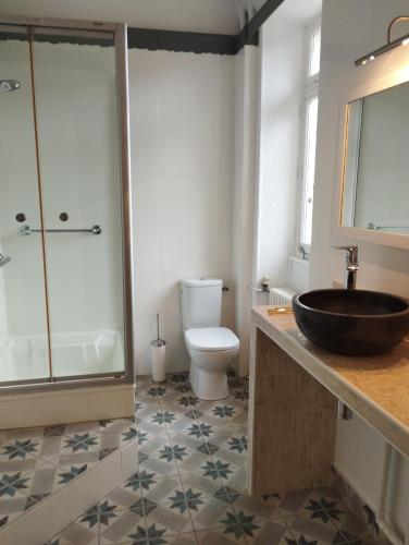 a bathroom with a sink and a toilet and a shower at Ma Tranquillite in Courpière