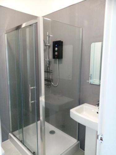 a bathroom with a shower and a sink at Glan Conwy House One and Two Bedroom Apartments in Llanrwst