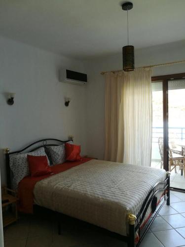 a bedroom with a bed with red pillows at Cabo Dream a Cabo Negro in Cabo Negro