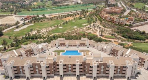 an aerial view of a building with a pool at Apartamento Al-Alba Golf Resort Valle del Este in Vera