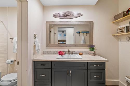 a bathroom with a sink and a mirror at Updated 1Br 1Ba Condo in the Kiahuna Plantation Resort near Poipu Beach 430 in Koloa