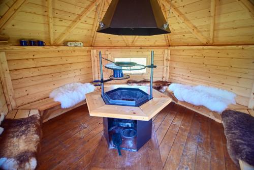 an inside view of a sauna with a table and couches at Willa Mycyny oraz domki in Mycyny