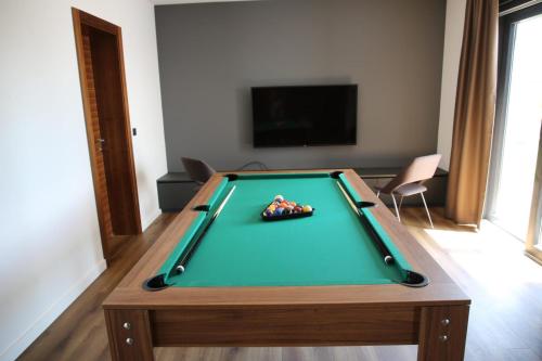 a pool table in a living room with afits at Villa Primavera in Novalja