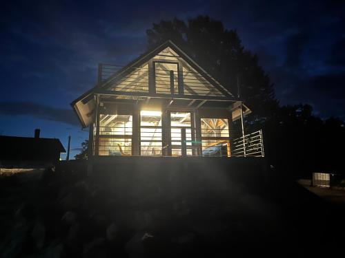 a house lit up at night with the sun shining at Domek Survivalowy w Spale in Spała