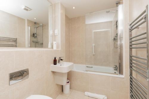 a bathroom with a sink and a shower and a toilet at Henley town centre with parking in Henley on Thames