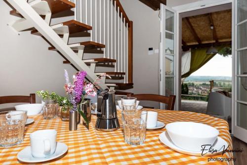 a table with a orange and white checkered table cloth at La casa delle Rondini in Forcoli