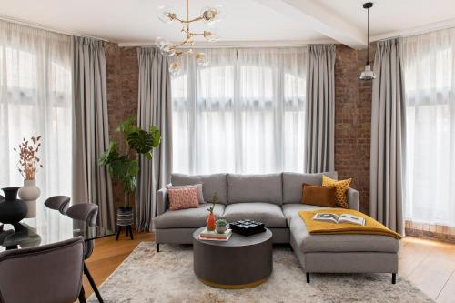 a living room with a couch and a table at COVE Arne Street in London