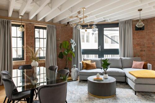 a living room with a couch and a table at COVE Arne Street in London