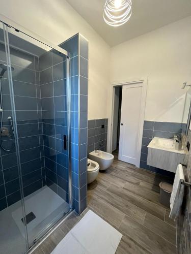a bathroom with a shower and a sink and a toilet at MaLuNa in Castelsardo