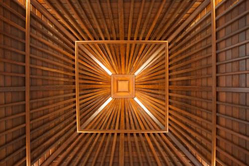 a wooden tunnel with a light at the end of it at Baruna Sari Villa in Ubud