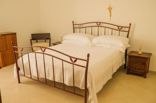 a bedroom with a large bed with white sheets and pillows at Suite Sabean by STHEY in Monopoli