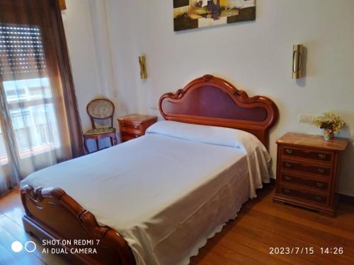 a bedroom with a bed and a dresser and a window at Apartamento calle Sainza 2 in Ourense