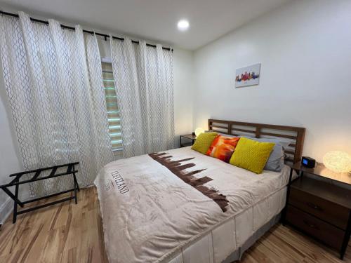 a bedroom with a bed and a window with curtains at Trendy in Tremont, CLE (Lower) in Cleveland