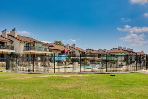 a fence in front of a yard with houses at Hot Springs Condo on Lake Hamilton with Views! in Hot Springs