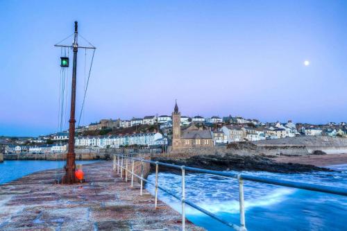 a light pole on a pier next to the water at Porthleven Glamping in Porthleven