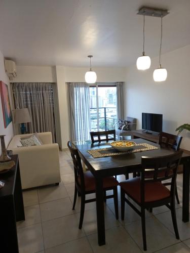 a dining room and living room with a table and chairs at Supercéntrico la Docta in Cordoba