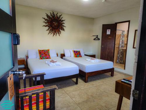 a living room with two beds and a couch at Fitz-Mar in Isla Mujeres